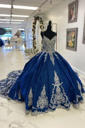 ivory lace appliqued shimmering blue glitter ball gown