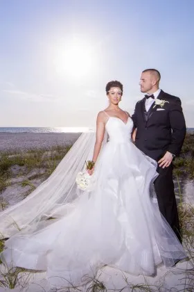 flounced white tulle outdoor ball gown wedding dress with spaghetti straps