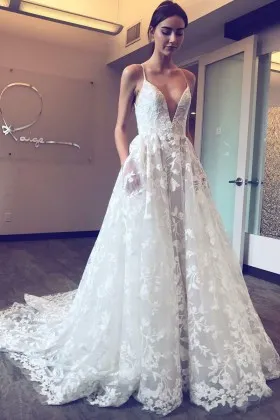 Floral lace and tulle whimsical plunging neckline wedding gown with spaghetti straps