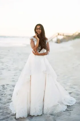 Ivory lace whimsical layered ball gown wedding dress with 34 sleeves
