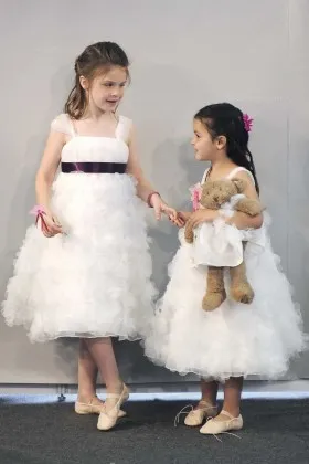 White ruffled tulle tea length flower girl dress with wide shoulder straps
